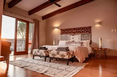 a bedroom with a large bed and a large window at 10onBrightside-Exp the epitome of country living in Nelspruit