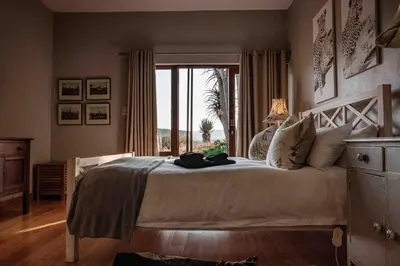 a bedroom with a large bed with a large window at 10onBrightside-Exp the epitome of country living in Nelspruit