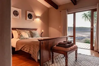 a bedroom with a bed and a large window at 10onBrightside-Exp the epitome of country living in Nelspruit