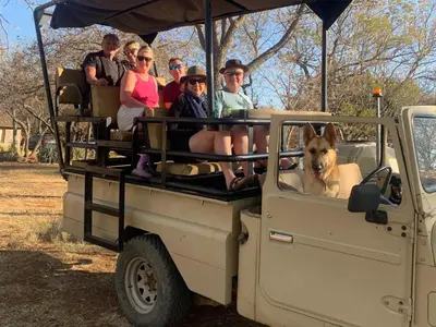 a group of people riding in the back of a truck at Simunye Private Game Reserve in Brits