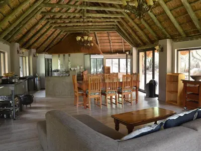 a living room with a couch and a table at Simunye Private Game Reserve in Brits