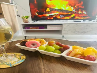 a tray of food on a table with a glass of wine at Cozy Pretoria Apartment with City Garden Views in Pretoria