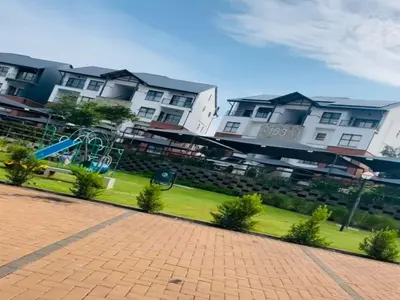 a row of houses with a playground in a park at Cozy Pretoria Apartment with City Garden Views in Pretoria
