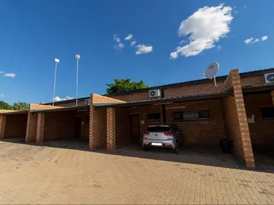 a car parked in front of a brick building at Somethin Special Guest House 77A in Mokopane