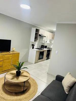a living room with a couch and a table at Homely Stay 4 in Kempton Park