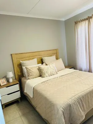 a bedroom with a large bed and a window at Homely Stay 4 in Kempton Park