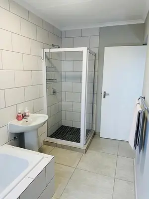 a bathroom with a shower and a sink at Homely Stay 4 in Kempton Park