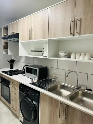 a kitchen with a sink and a stove at Homely Stay 4 in Kempton Park