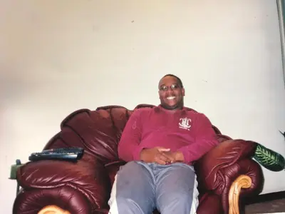 a man is sitting on a leather chair at Secret Place in Pretoria