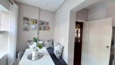 a room with a table with a vase on it at Secret Place in Pretoria