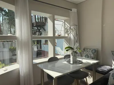 a table and chairs in a room with a window at Secret Place in Pretoria