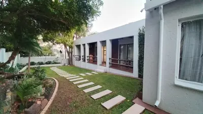 a house with a yard with stepping stones in front of it at Secret Place in Pretoria