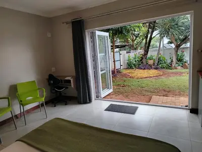a bedroom with a large sliding glass door to a yard at Grace 523 in Pretoria