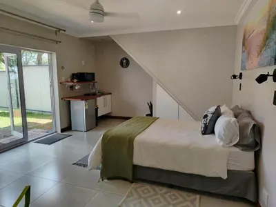 a bedroom with a bed and a staircase in a room at Grace 523 in Pretoria
