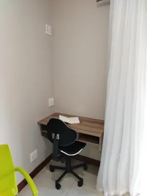 a desk with a chair next to a window at Grace 523 in Pretoria