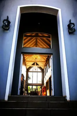 a blue building with stairs and a window at Belle Vie Boutique Guesthouse in Pretoria