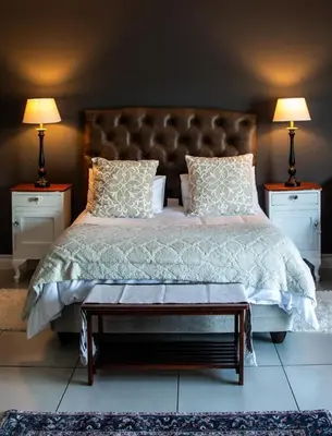 a bedroom with a large bed with two night stands at Belle Vie Boutique Guesthouse in Pretoria