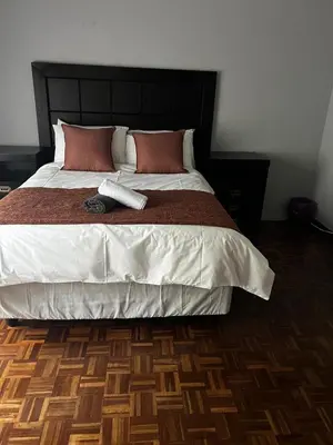 a bedroom with a large bed with a phone on it at Emoyeni Malelane Lodge in Malelane