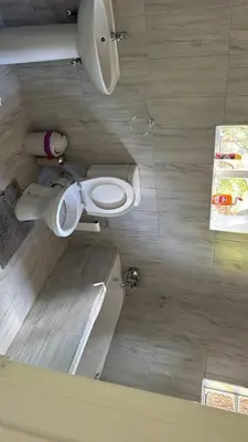 a bathroom with a white toilet in a room at Emoyeni Malelane Lodge in Malelane
