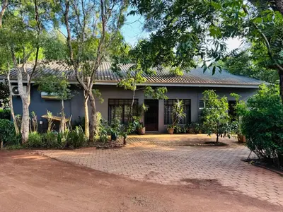 a house with a brick driveway in front of it at Emoyeni Malelane Lodge in Malelane