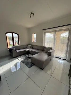 a living room with a couch and a table at Home away from Home in Midrand