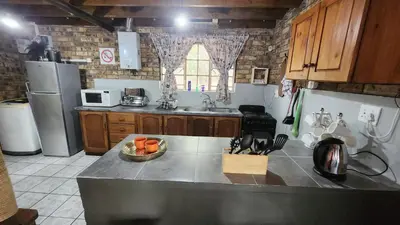 a kitchen with a sink and a counter top at Parradys Marloth Park in Marloth Park