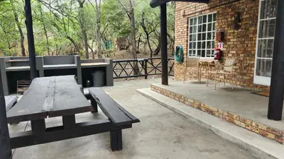 a patio with a picnic table and a building at Parradys Marloth Park in Marloth Park