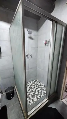 a shower with a glass door in a bathroom at Parradys Marloth Park in Marloth Park