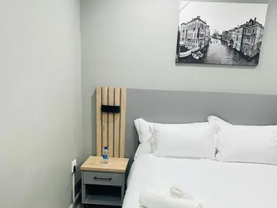 a bedroom with a bed and a nightstand with a picture at Ngwede Guest House in Lydenburg