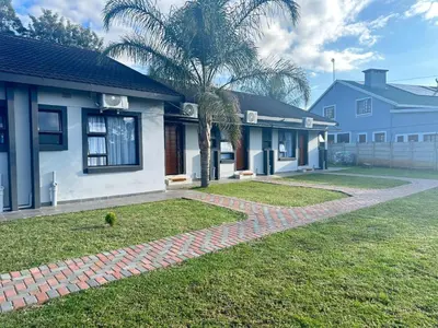 a house with a palm tree in the yard at Ngwede Guest House in Lydenburg
