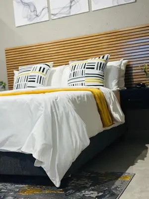 a large bed with white sheets and pillows at Impèrio Boutique Guest Lodge in Siyabuswa