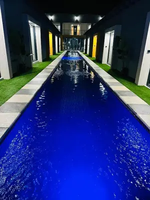 a pool with blue water in a house at Impèrio Boutique Guest Lodge in Siyabuswa