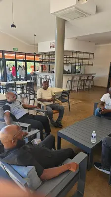 a group of people sitting on tables in a room at Matsila Game Lodge in Thohoyandou