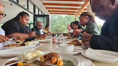 a group of people sitting at a table eating food at Matsila Game Lodge in Thohoyandou