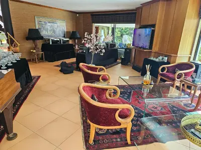 a living room with chairs and a glass table at The Embassy in Pretoria
