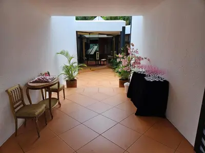 a hallway with a table and chairs and plants at The Embassy in Pretoria
