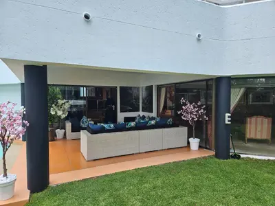 a living room with a couch on a patio at The Embassy in Pretoria