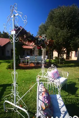 a couple of chairs sitting in the grass at Villa Afriq in Lydenburg