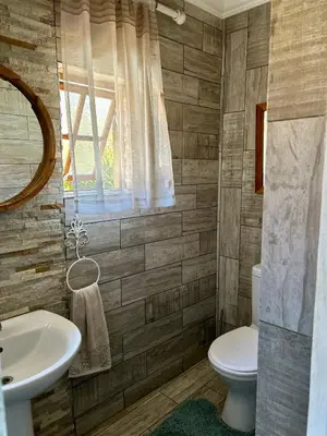 a bathroom with a toilet and a sink at Villa Afriq in Lydenburg
