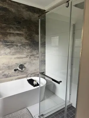 a bathroom with a glass shower and a sink at Attorneys Place in Pretoria