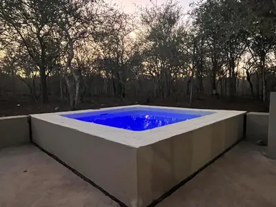 a large tub with a blue water in it at Erdvarkie at Kruger, Marloth Park in Marloth Park