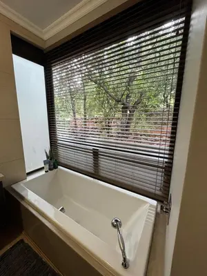a large white bath tub in a bathroom with a window at Zwartkloof 111 in Warmbaths