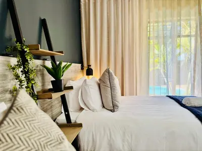 a bedroom with a white bed and a window at 34 Saligna st - 6 Guests Self Catering in Polokwane