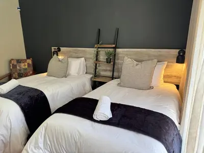 a room with two beds with pillows on them at 34 Saligna st - 6 Guests Self Catering in Polokwane