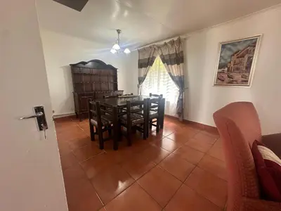 a dining room with a table and chairs at The Lake Villa 2 in Benoni