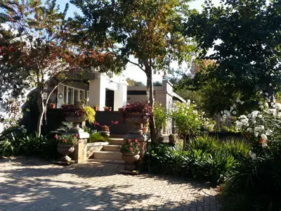 a house with flowers and plants in front of it at At 98 on Lynburn Guest House in Pretoria