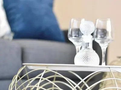 a glass vase sitting on a table next to a couch at Mbizo Cozy Retreat- Lofts at Loftus in Pretoria