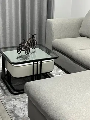 a small motorcycle sitting on a glass table in a living room at The Snug Spot in Boksburg