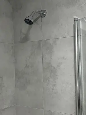 a shower with a shower head in a bathroom at The Snug Spot in Boksburg