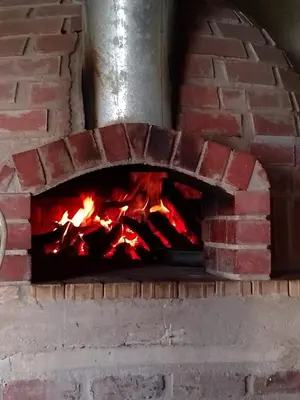 a brick oven with a fire in it at Klipspringer Lodge in Nelspruit
